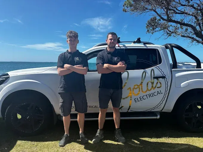 The Golds Electrical team beside their branded ute on the Hibiscus Coast